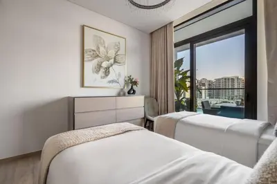 a hotel room with two beds and a window at GuestReady - Upscale living at Palace Residence in Dubai