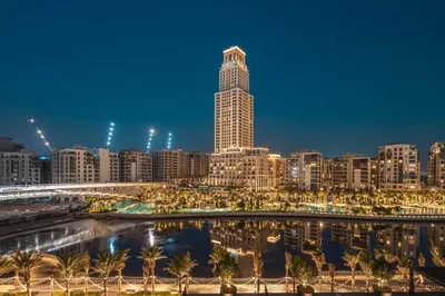 a view of a city skyline at night at GuestReady - Upscale living at Palace Residence in Dubai