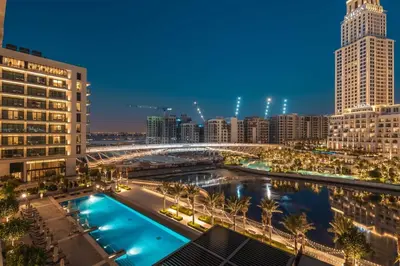 a view of a city skyline at night at GuestReady - Upscale living at Palace Residence in Dubai