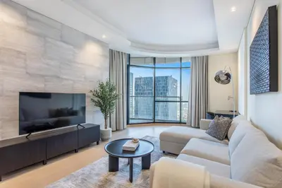 a living room with a couch and a tv at Modern Comfort1BR RP Heights 5-min Dubai Mall in Dubai