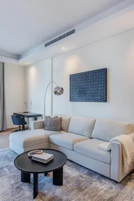 a living room with a couch and a table at Modern Comfort1BR RP Heights 5-min Dubai Mall in Dubai