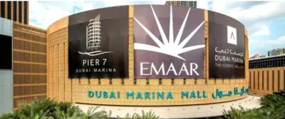 a sign in front of a building with a microphone at Stunning Apartment, Partial Sea View, Canal Marina View, 5 min walk To JBR Beach and METRO in Dubai