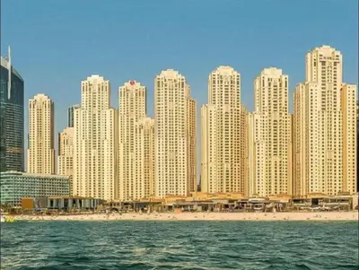 a skyline of a city with a beach and buildings at Stunning Apartment, Partial Sea View, Canal Marina View, 5 min walk To JBR Beach and METRO in Dubai