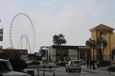 a city with a ferris wheel in the background at Stunning Apartment, Partial Sea View, Canal Marina View, 5 min walk To JBR Beach and METRO in Dubai