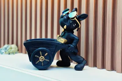 a figurine of a mickey mouse pushing a cart at Luxury Studio - Downtown Dubai 6 Minute Walk to Burj Khalifa & Dubai Mall in Dubai