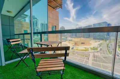 a balcony with a bench and a view of a city at Luxury Studio - Downtown Dubai 6 Minute Walk to Burj Khalifa & Dubai Mall in Dubai