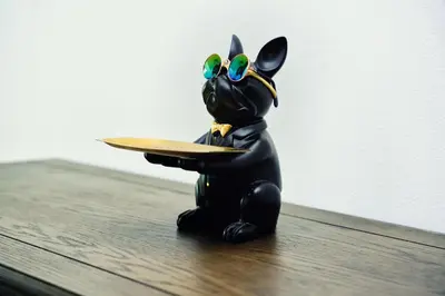 a small figurine of a dog holding a plate at Luxury Studio - Downtown Dubai 6 Minute Walk to Burj Khalifa & Dubai Mall in Dubai