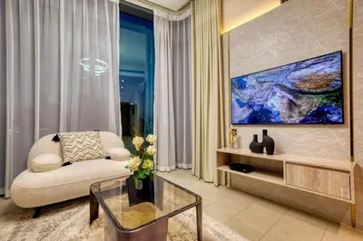 a living room with a couch and a glass table at Apartment 1015 Waves in Dubai