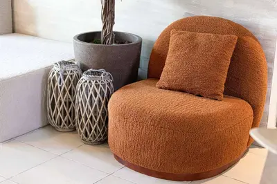 a brown chair sitting next to a vase at Marina Elegance, Your Dream Dubai Marina Stay in Dubai