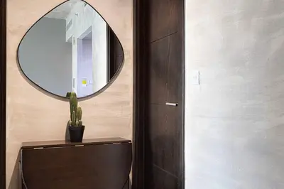 a bathroom with a mirror on the wall and a toilet at Marina Elegance, Your Dream Dubai Marina Stay in Dubai