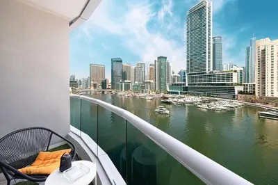 a balcony with a view of a river and buildings at Marina Elegance, Your Dream Dubai Marina Stay in Dubai