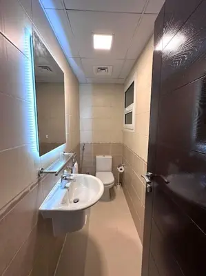 a bathroom with a sink and a toilet and a mirror at Luxury sea-view apartment in Dubai