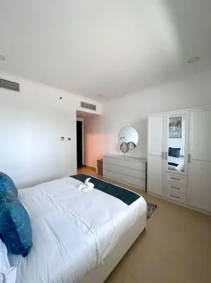 a bedroom with a large white bed in a room at Luxury sea-view apartment in Dubai