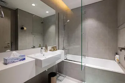 a bathroom with a sink and a shower at Luxury Apt Burj Khalifa, Sunset and Lagoon view in Dubai