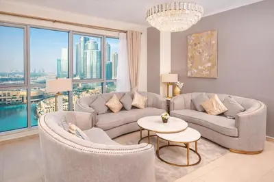 a living room with a couch and chairs and a table at Elite Royal Apartment - Sky Series - Breathtaking View - Full Burj Khalifa & Fountain in Dubai