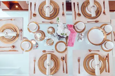 a table with plates and utensils on it at Elite Royal Apartment - Sky Series - Breathtaking View - Full Burj Khalifa & Fountain in Dubai