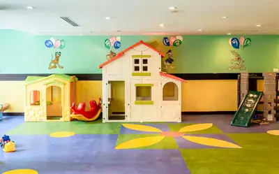 a play room with a toy house and a slide at Elite Royal Apartment - Sky Series - Breathtaking View - Full Burj Khalifa & Fountain in Dubai