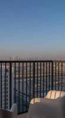 a balcony with a couch and a view of a city at Offer! 1BR, Skyline View, Dubai Hills Estate, Park Ridge in Dubai