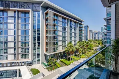 an exterior view of a building with palm trees at Mira Holiday Homes - Luxury 2 bedroom in Bluewaters with stunning view in Dubai