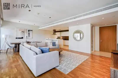 a living room with a couch and a table at Mira Holiday Homes - Luxury 2 bedroom in Bluewaters with stunning view in Dubai