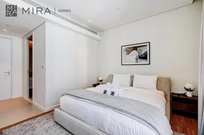 a white bedroom with a large bed in a room at Mira Holiday Homes - Luxury 2 bedroom in Bluewaters with stunning view in Dubai