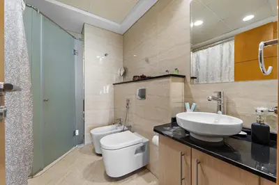 a bathroom with a white toilet and a sink at StoneTree - High Floor - Prime location in Dubai