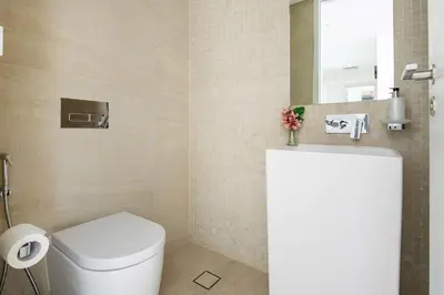 a bathroom with a white toilet and a mirror at Frank Porter - Bluewaters Residences Building 5 in Dubai