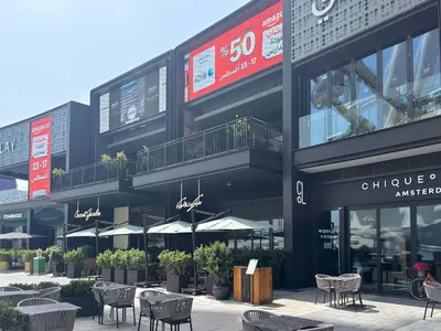 a building with tables and chairs in front of it at Frank Porter - Bluewaters Residences Building 5 in Dubai