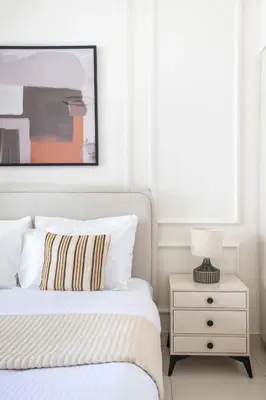 a white bedroom with a bed and a nightstand at Frank Porter - Park Point Building C in Dubai