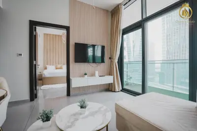 a living room with a bed and a large window at Queens Estate Vacation Homes - Merano Tower, Business Bay in Dubai