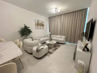a living room with couches and a table at Spacious 1bedroom W Lagoon In Al Maktoum City in Dubai