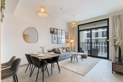 a living room with a table and a couch at Wilton Terraces T1 - 1BR Apartment - Allsopp&Allsopp in Dubai