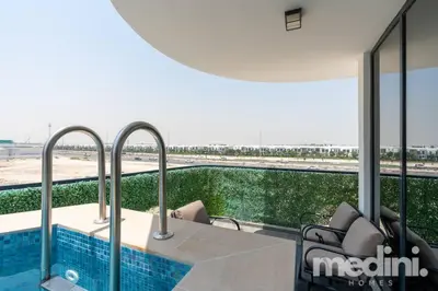 a view of a swimming pool from a building at 2 bhk with Private Pool - Samana Golf Avenue - Dubai in Dubai