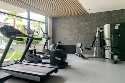 a gym with several treadmills and exercise bikes at Oxford Boulevard - Studio - JVC Dubai in Dubai