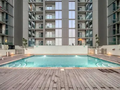 an empty swimming pool in a building with tall buildings at The Smarft Concierge - Sobha Creek Vista in Dubai