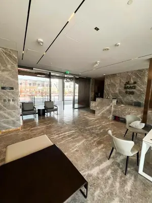 a lobby with a table and chairs in a building at AWS Holiday Homes - Chic Downtown Views in Dubai