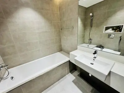 a bathroom with a tub and a sink and a bath tub at Fully Furnished 1br W Relaxing Lagoon View in Dubai