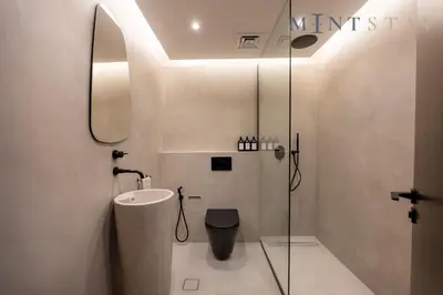 a bathroom with a sink and a toilet and a mirror at Sky Gardens, Park Avenue, DIFC - Mint Stay in Dubai