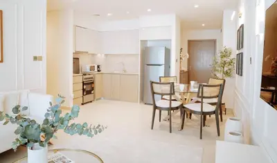 a kitchen and dining room with a table and chairs at Burj Royale Condo, Close to Dubai Mall & Attractions in Dubai