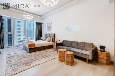 a living room with a bed and a couch at Mira Holiday Homes - Fully Furnished Studio in JLT in Dubai