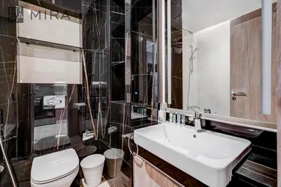 a bathroom with a white sink and a toilet at Mira Holiday Homes - Fully Furnished Studio in JLT in Dubai