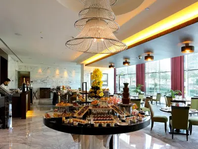 a restaurant with a buffet in the middle of a room at Cosmos Living Charming Studio With Balcony in Dubai