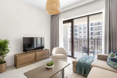 a living room with a couch and a tv at Silkhaus Chic 1BDR In Unique Neighborhood in Dubai