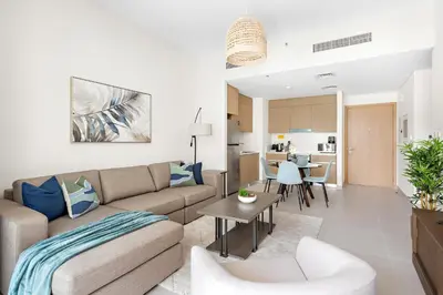 a living room with a couch and a table at Silkhaus Chic 1BDR In Unique Neighborhood in Dubai