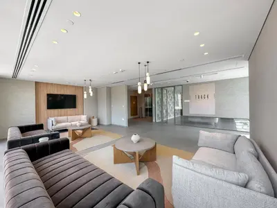 a large living room with couches and a tv at Elegant - 1BR - 8 MIN Burj Khalifa & Dubai Mall in Dubai