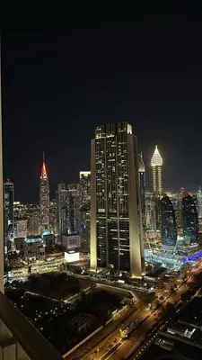 a view of a city at night with traffic at Elegant - 1BR - 8 MIN Burj Khalifa & Dubai Mall in Dubai