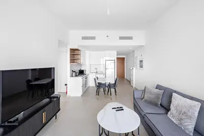 a living room with a couch and a table at Elegant - 1BR - 8 MIN Burj Khalifa & Dubai Mall in Dubai