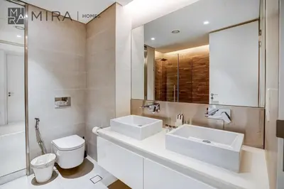 a bathroom with a sink and a toilet and a mirror at Mira Holiday Homes - Lovely 3 bedroom in Bluewaters with sea view in Dubai