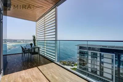 a balcony with a table and a view of the ocean at Mira Holiday Homes - Lovely 3 bedroom in Bluewaters with sea view in Dubai