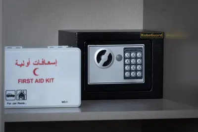 a small appliance sitting on a shelf with a first aid kit at Waves - Comfort and Style in a 21st-Floor Studio With View in Dubai